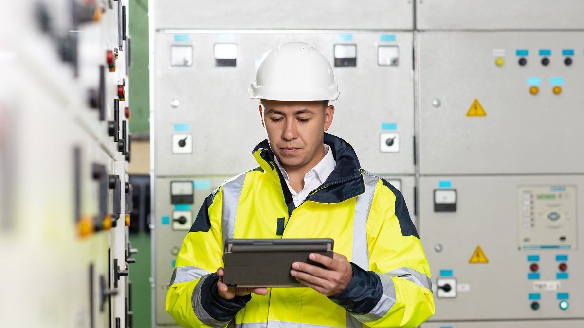 Technician inspect to control panel screen system for generate electricity of factory in manufacture industrial. Man electrical engineer hold tablet monitoring electrical system in control room.
