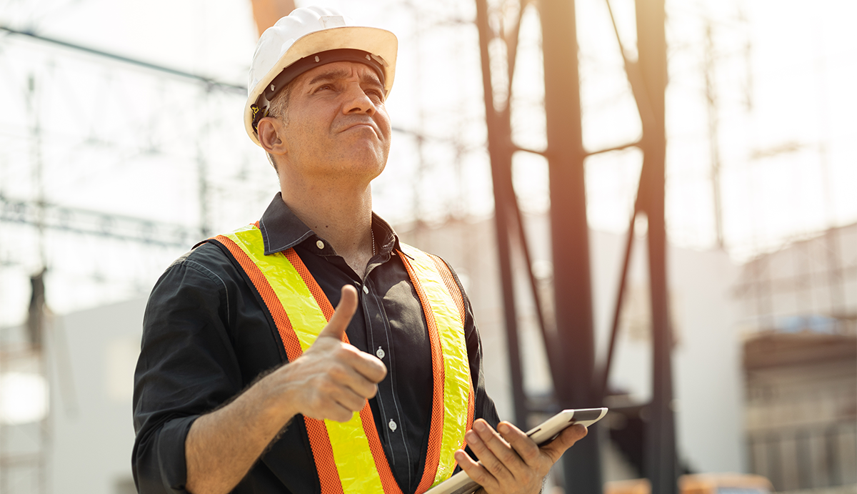 Professional Caucasian Engineer male builder working at construction site work outdoor with safety.