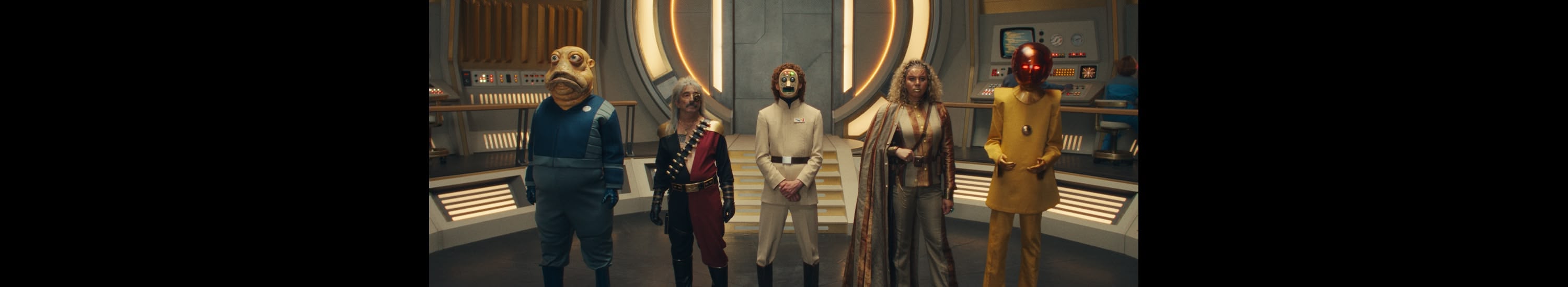 Several evil villains standing at attention inside a spaceship.