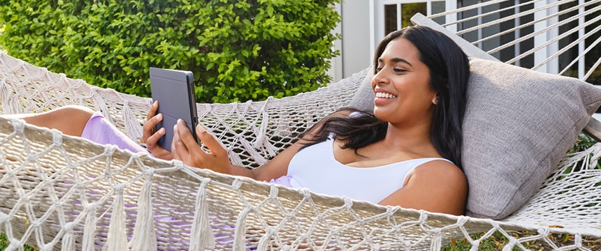 Lady on a hammock using a tablet
