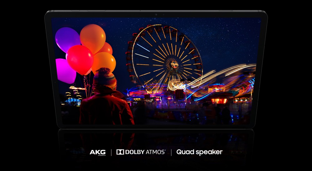 The display shows a vivid picture of an amusement park at night, with fireworks extending beyond the screen