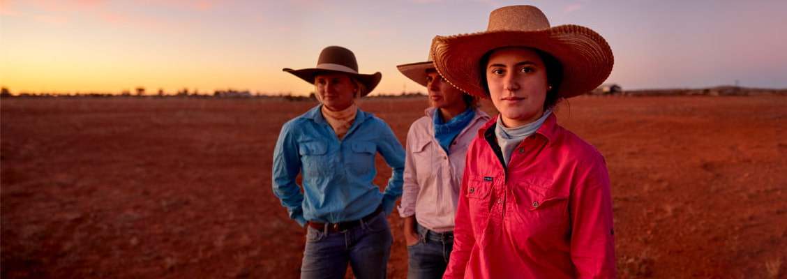 3 women wearing Akubra hats in outback setting