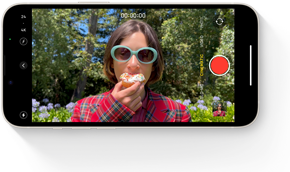 A frame of an Cinematic mode clip showing a person eating a cupcake.