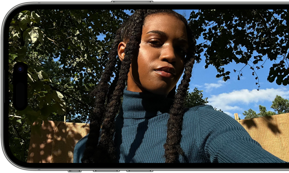 A horizontal view of an iPhone 14 Pro displaying a sharp and vibrant selfie.