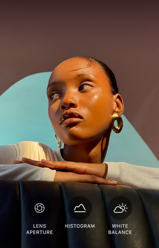 Close up portrait of a well-lit model with a colourful background, demonstrating the pro camera system's Pro controls UI: Aperture, Histogram, White Balance