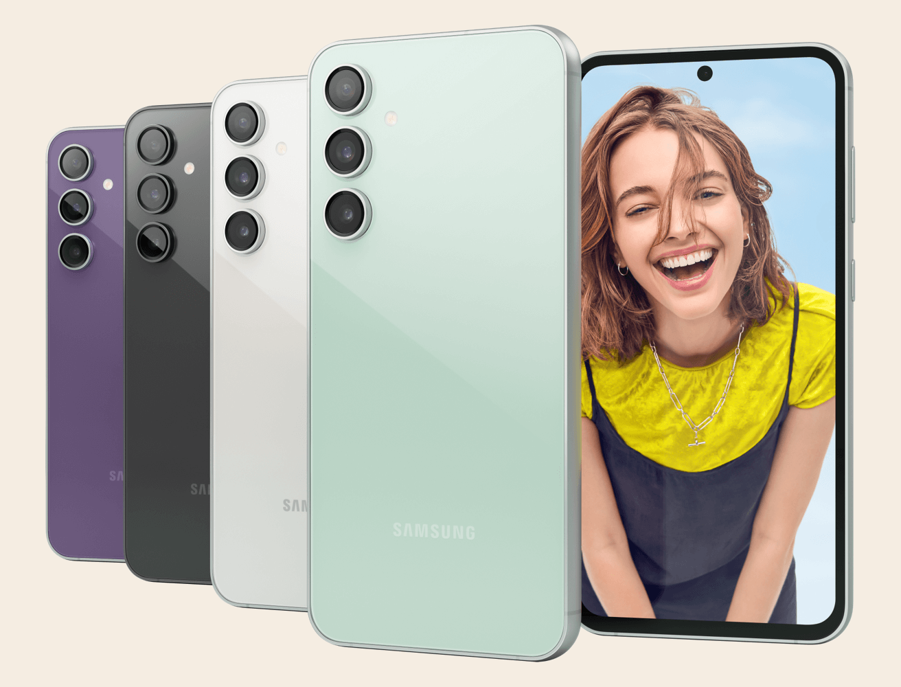Rear view of four Samsung S23 FE in colours Mint, Cream, Graphite and Purple and front view of Samsung S23 FE with metallic silver side panel visible. Wallpaper on front facing phone depicts a photo of an adult with a smile pose. 