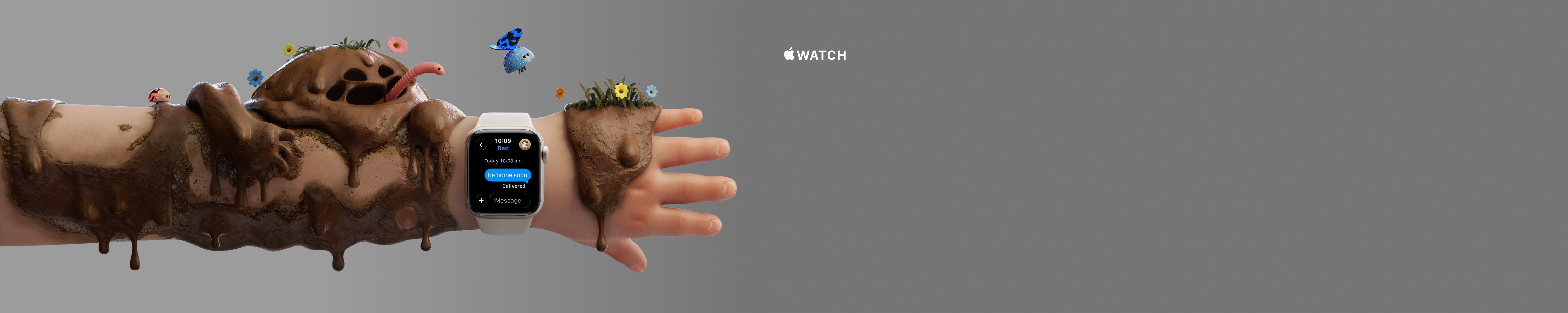 Apple Watch with white sport band displaying an iMessage conversation with Dad. A text reads "be home soon" on wrist, surrounded by a surreal mud-covered arm sculpture with flowers, grass and a worm against a grey background.