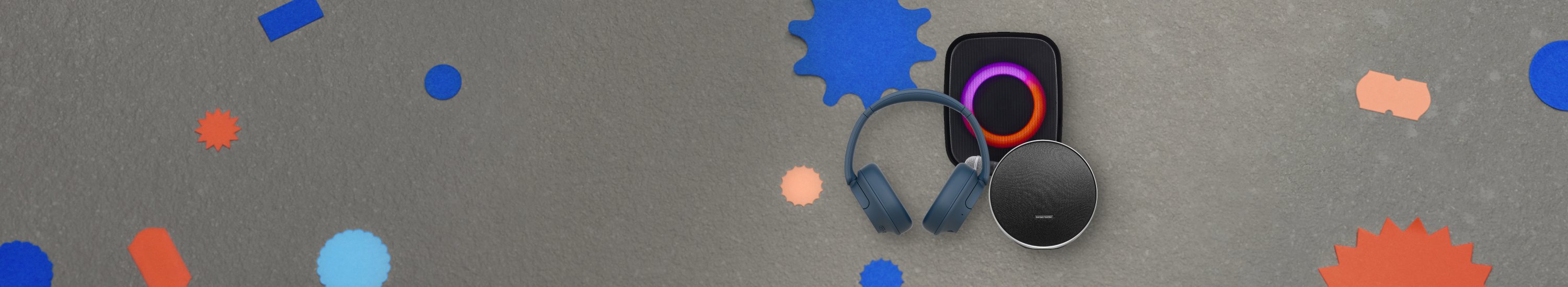 Image showing three audio accessories. Blue Sony WH-CH720N Wireless Headphones, black Sprout Soundloop Party Speaker, and black Harman Kardon Onyx Studio 9 Bluetooth Speaker.