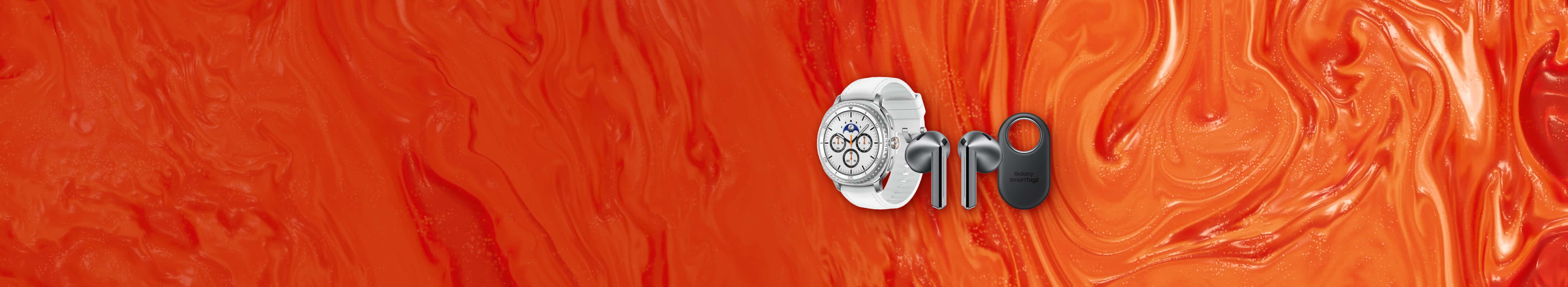 Flat lay image of Samsung accessories against orange background. Left to right: Samsung Galaxy Watch8 Classic with white band, silver Samsung Buds3, and Samsung SmartTag.