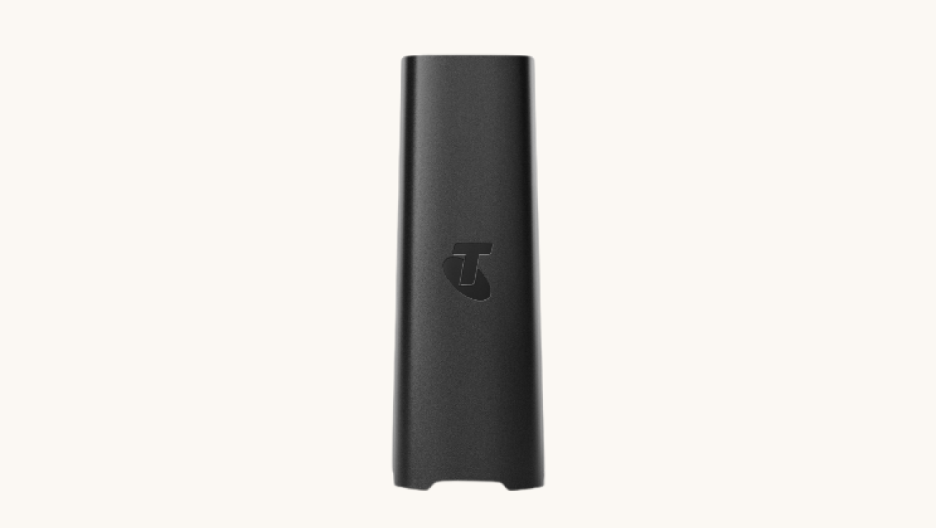 Telstra Smart Wi-Fi Booster in a sleek black design with a compact rectangular shape, featuring a Telstra logo on the front.