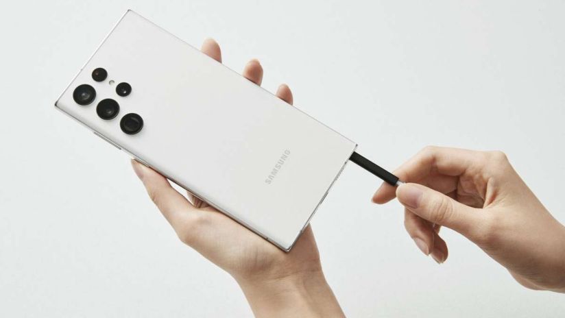 The Samsung Galaxy S22 Ultra smartphone, showing its removable S-Pen being inserted.